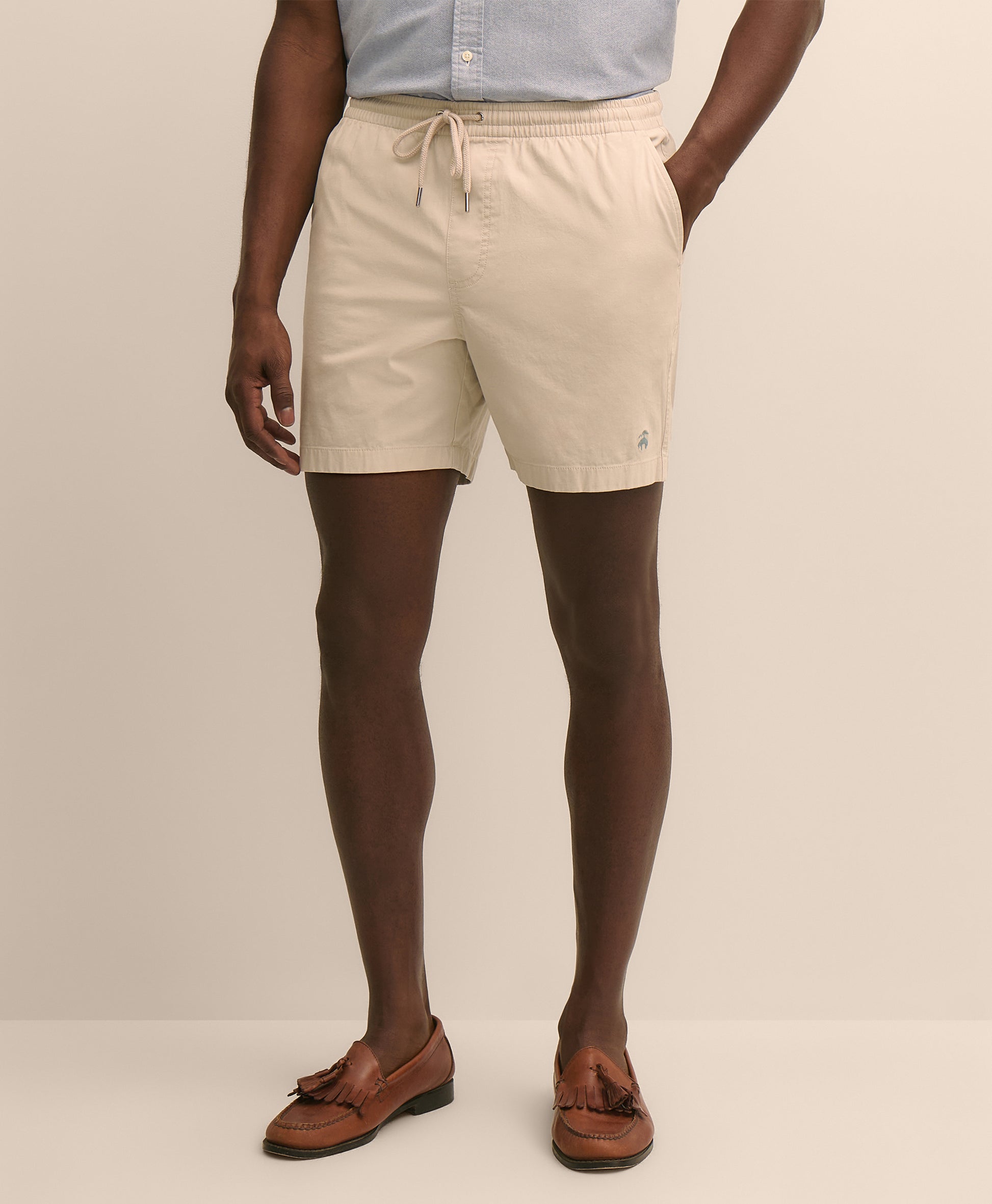 Person wearing beige shorts
