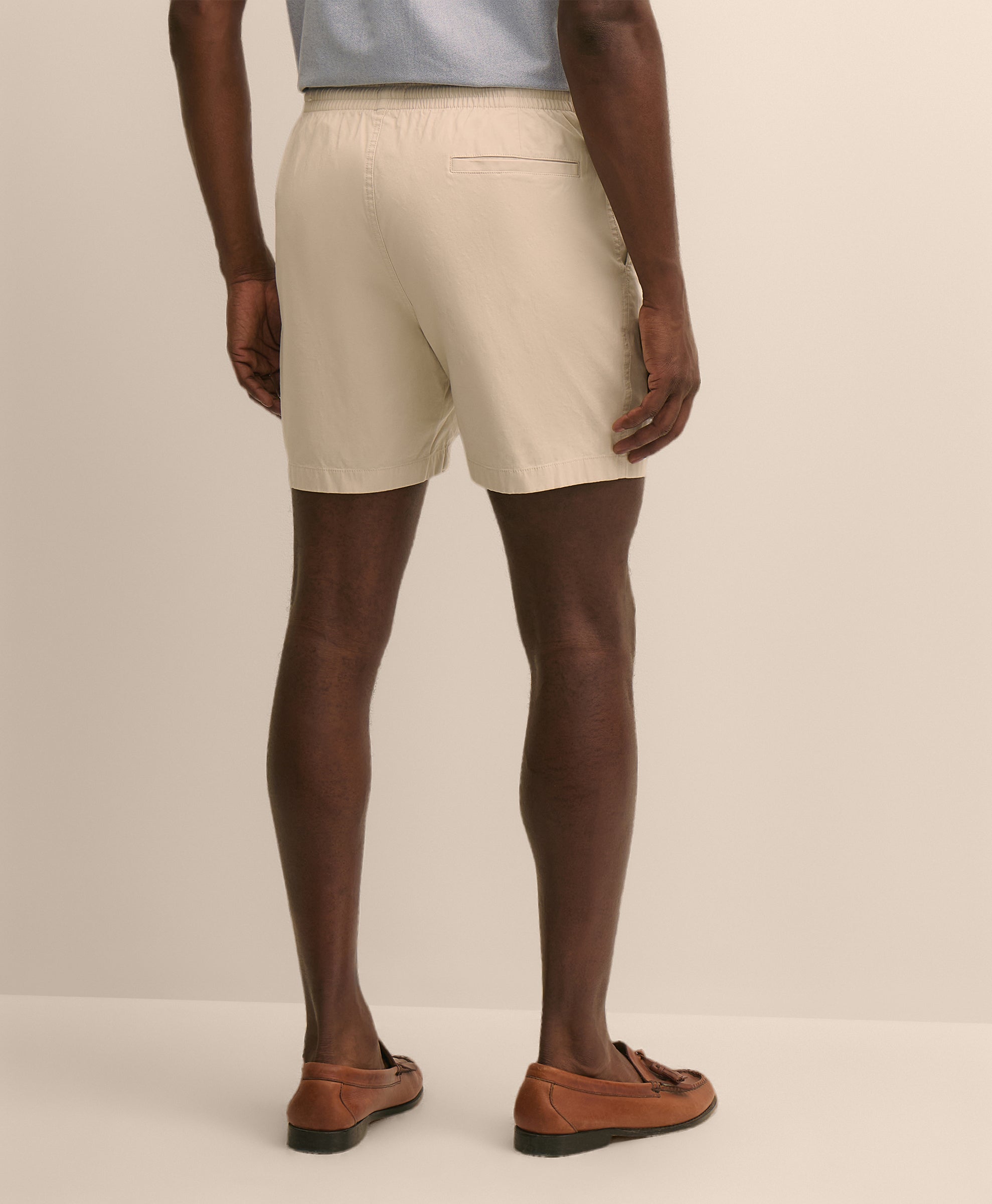 Person wearing beige shorts