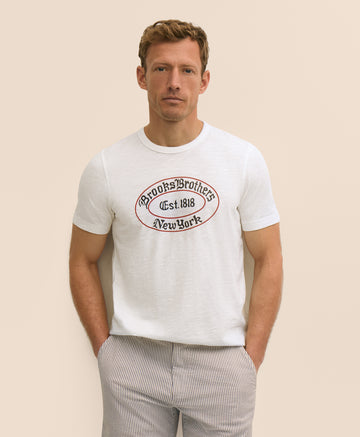 Man wearing a white t-shirt with a logo