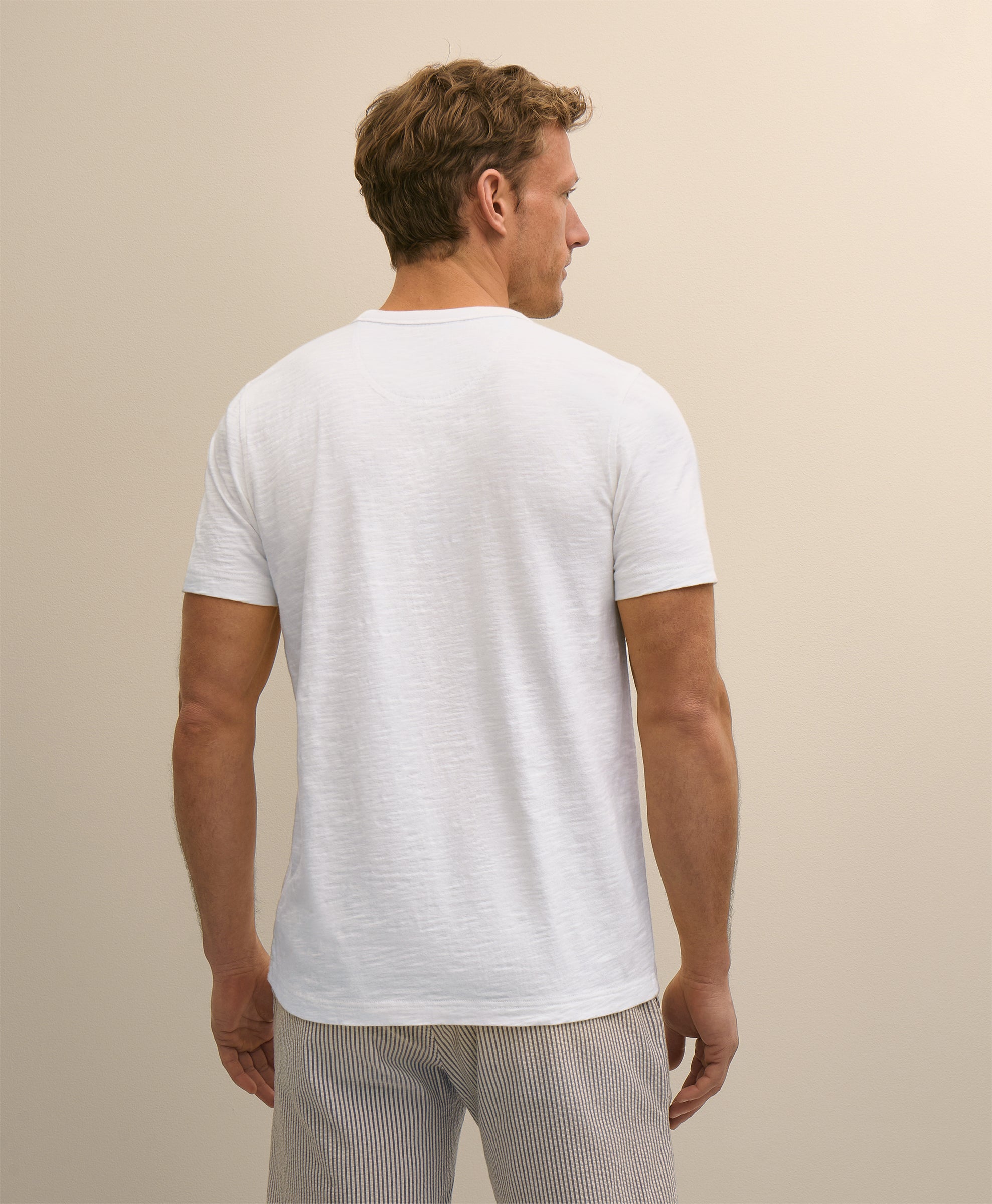 Man wearing a white t-shirt and light gray pants