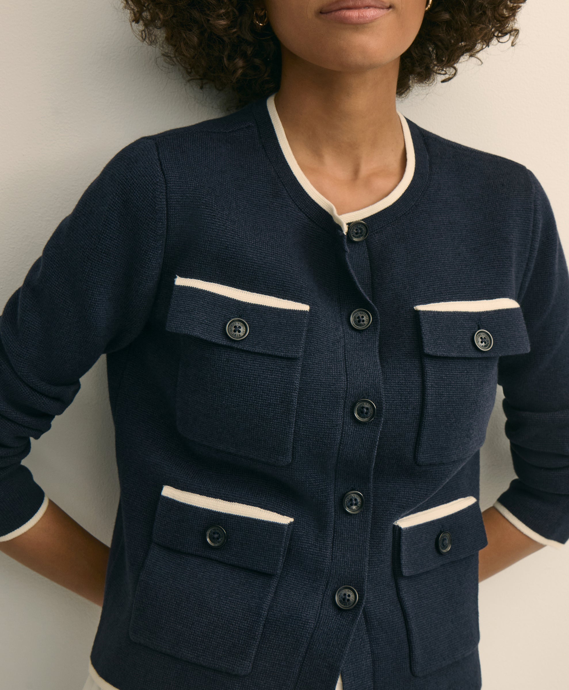 Navy blue jacket with white trim worn by a person