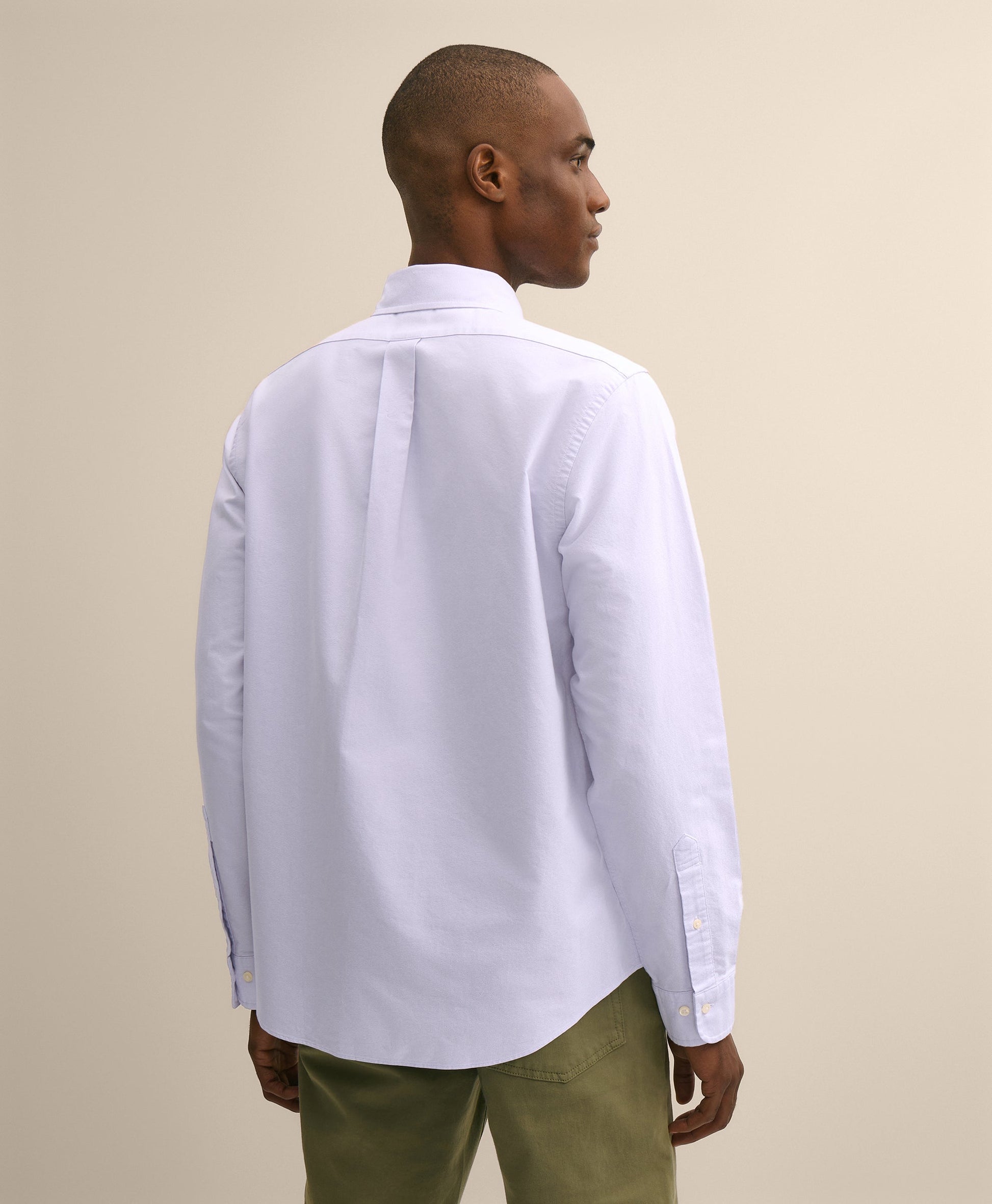 Man wearing a white shirt and green pants