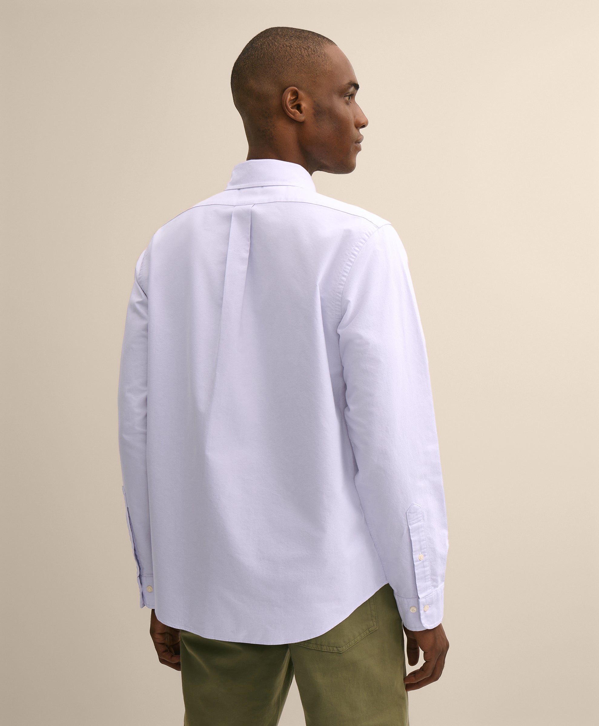 Man wearing a white shirt and green pants