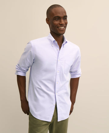 Man wearing a light purple button-up shirt and green pants