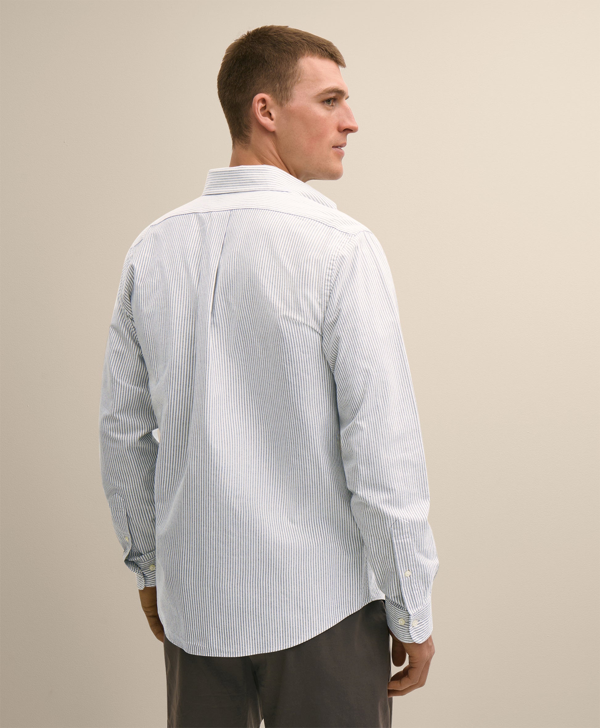 Man wearing a light-colored striped shirt