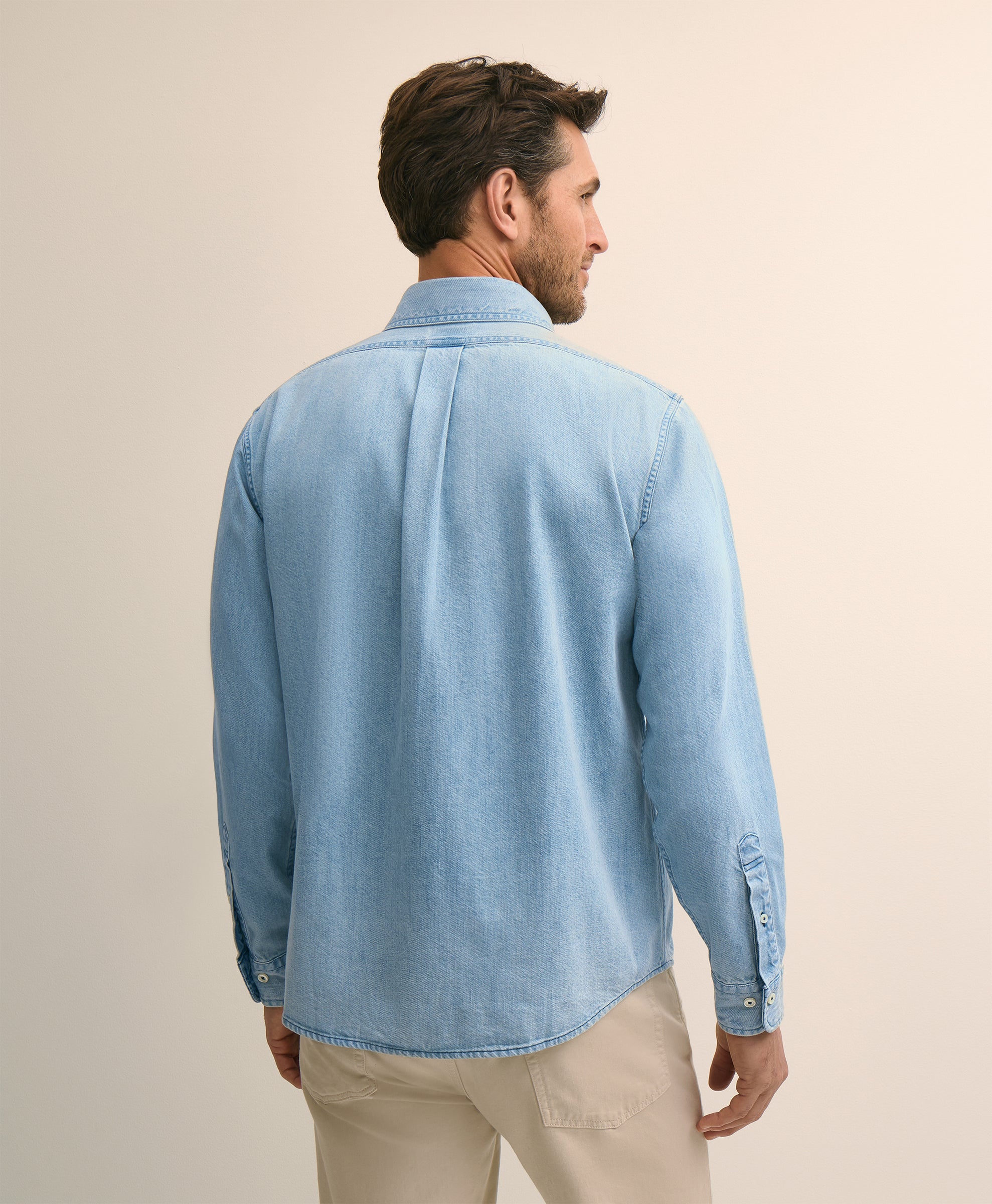 Man wearing a light blue denim shirt