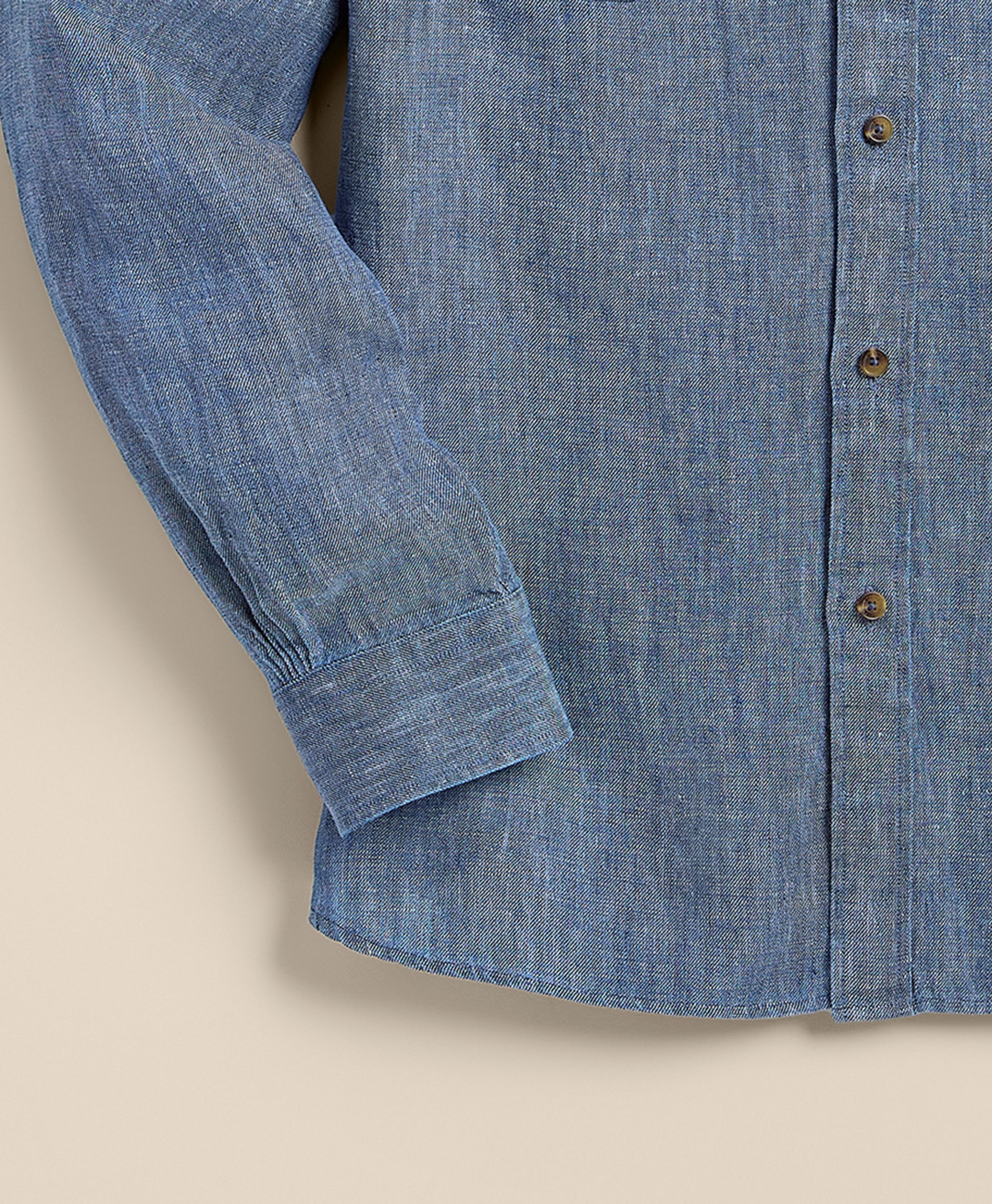 Close-up of a blue denim shirt with buttons