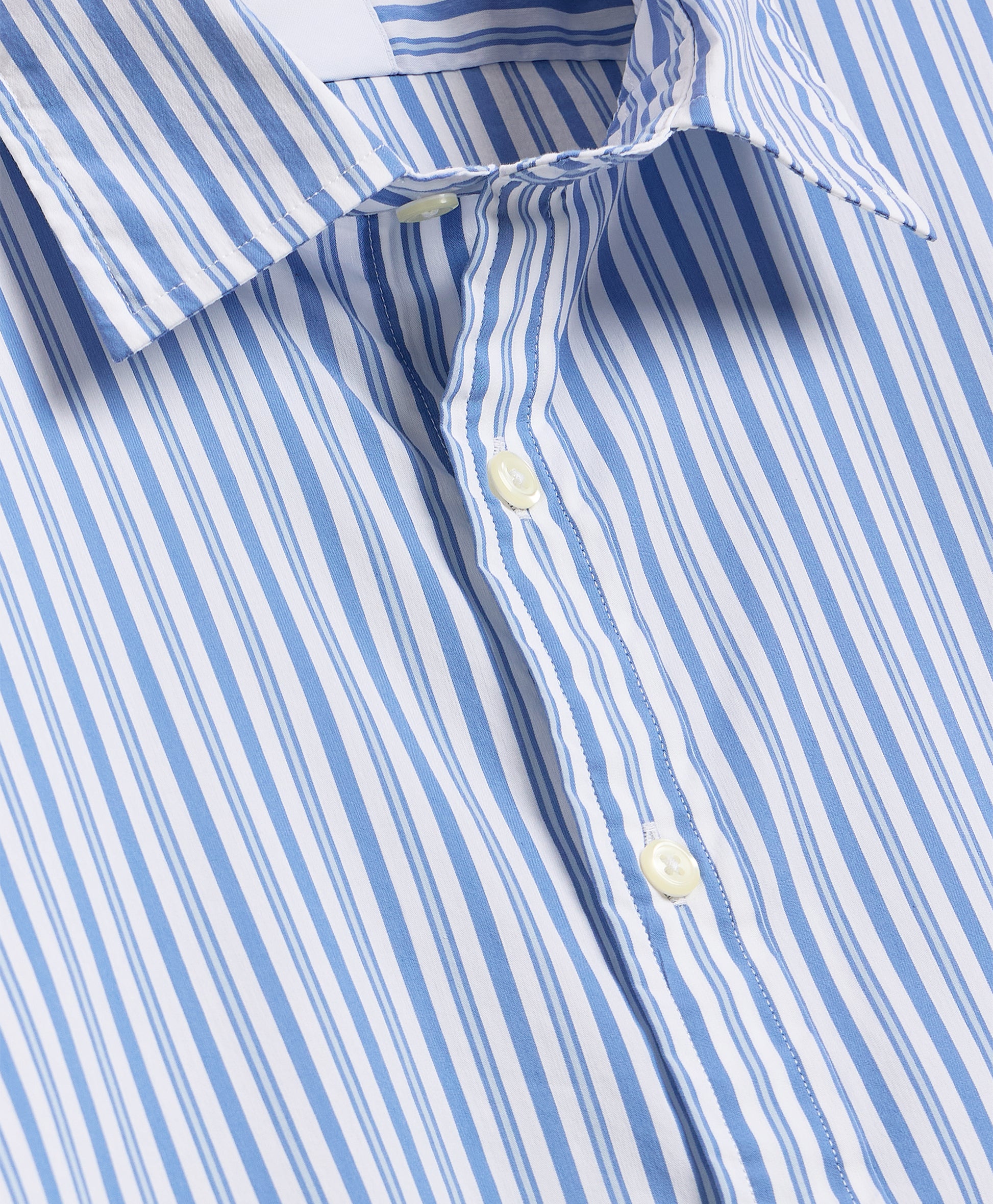 Close-up of button-down collar and anchor print on navy fabric.
