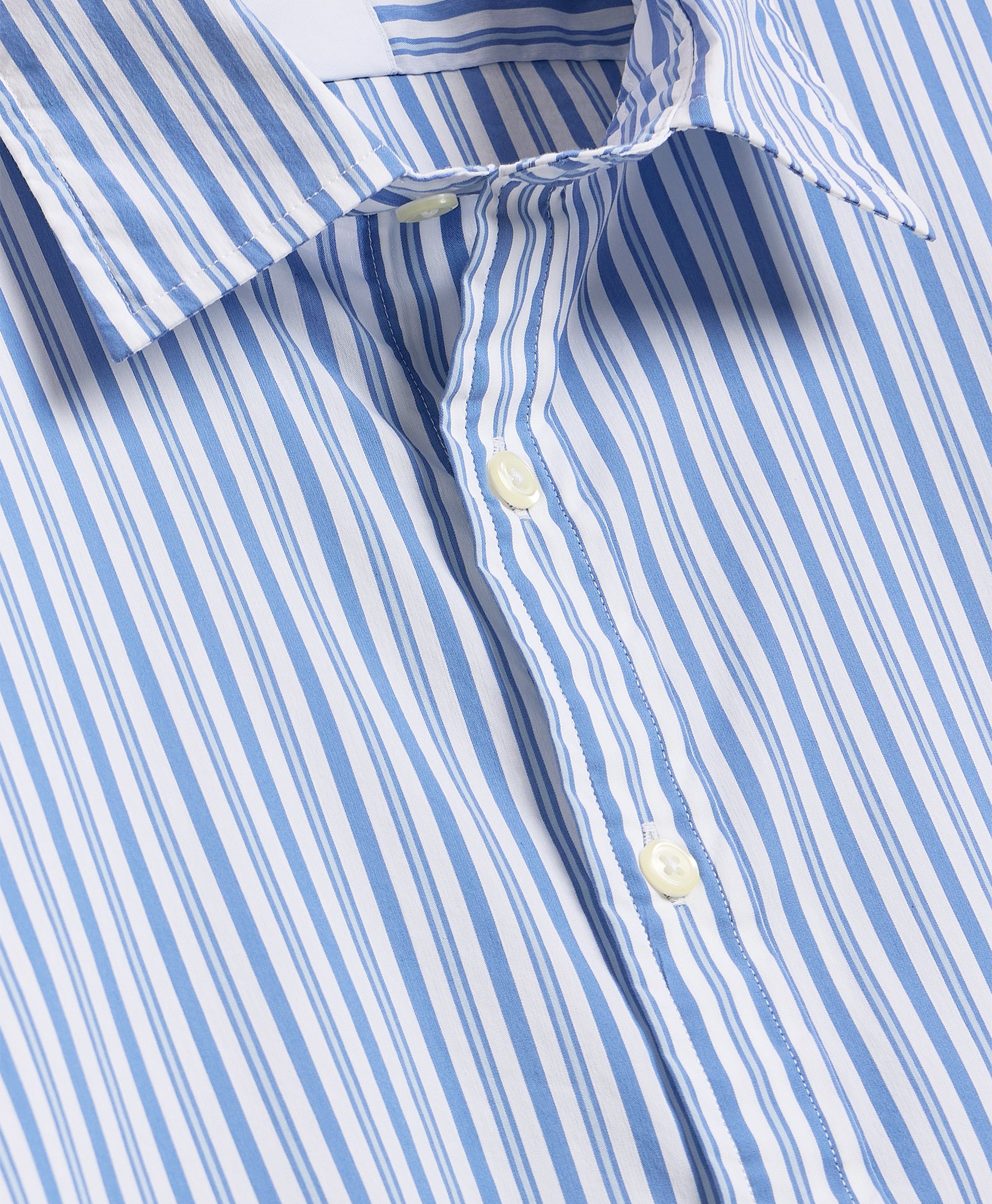 Close-up of button-down collar and anchor print on navy fabric.