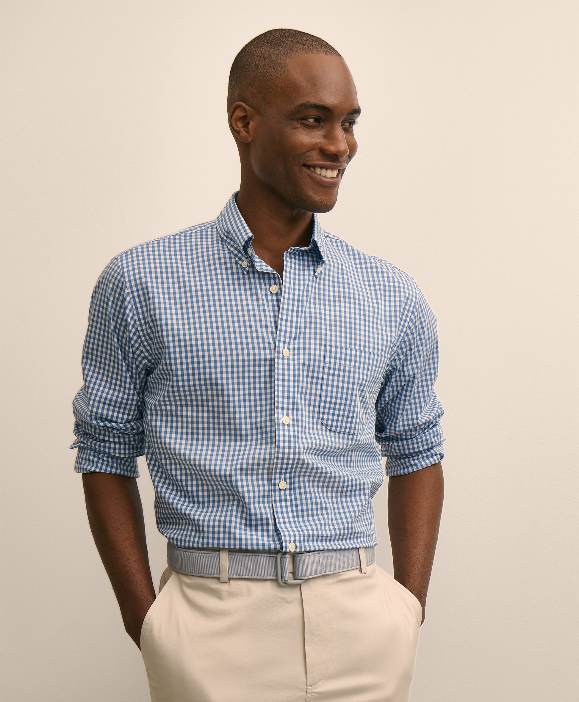 Man wearing a blue checkered shirt and beige pants
