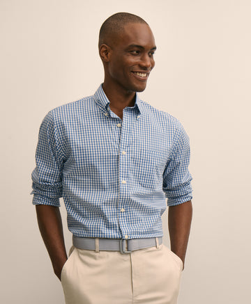 Man wearing a blue checkered shirt and beige pants