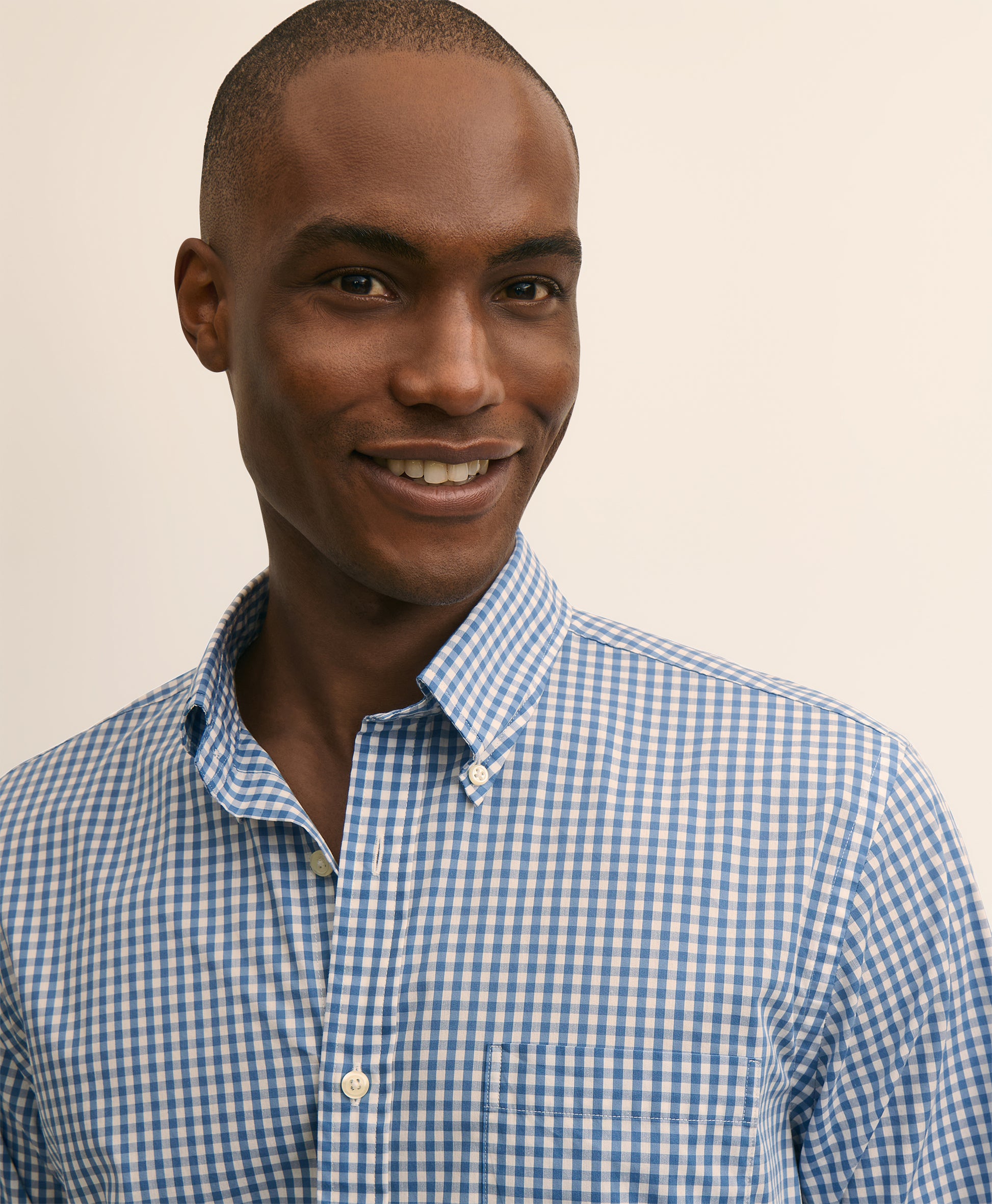 Man wearing a blue and white checkered shirt