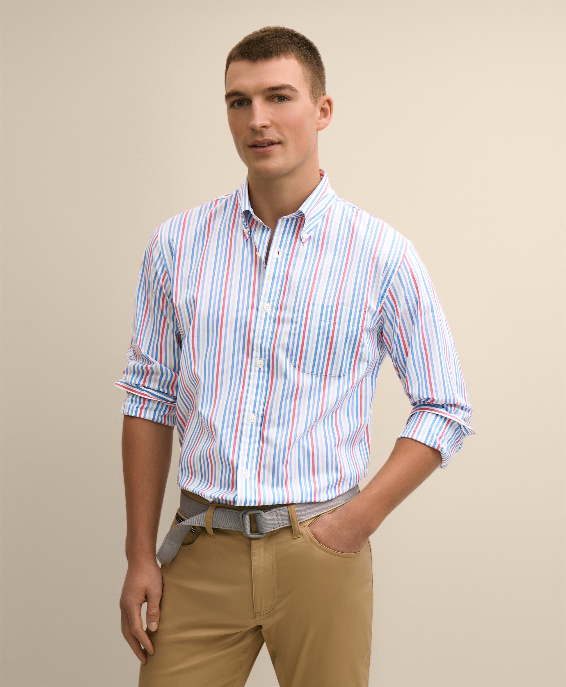 Man wearing a striped shirt and beige pants