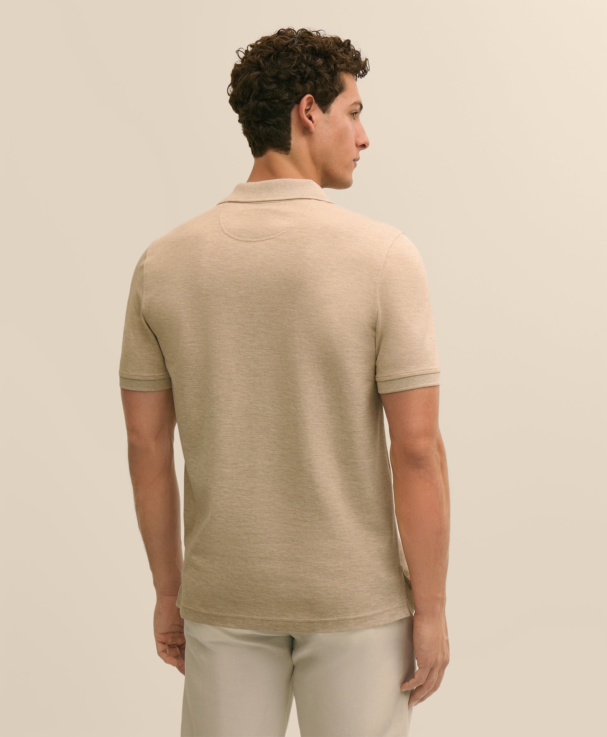 Man wearing a beige polo shirt