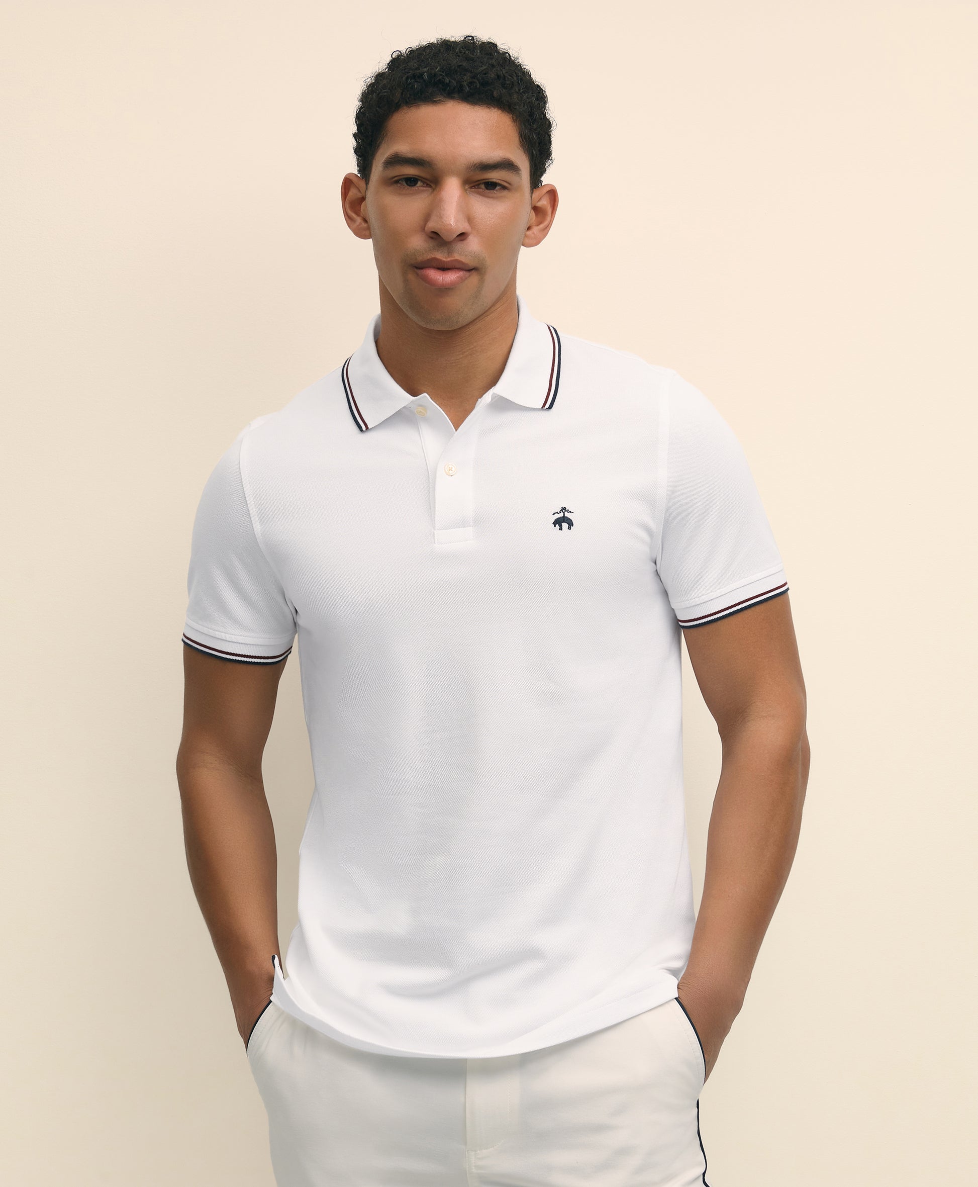 Man wearing a white polo shirt with black trim