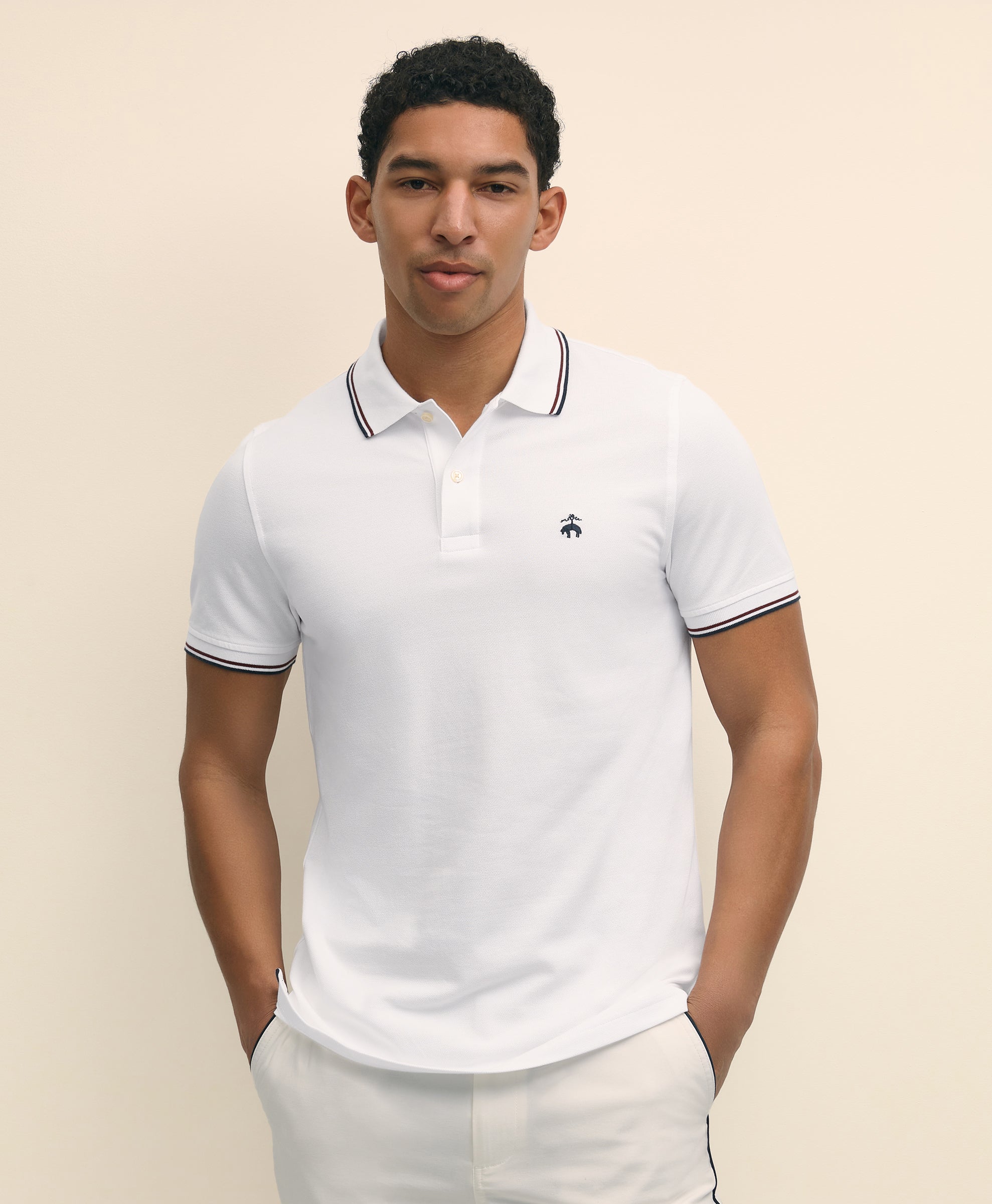 Man wearing a white polo shirt with black trim