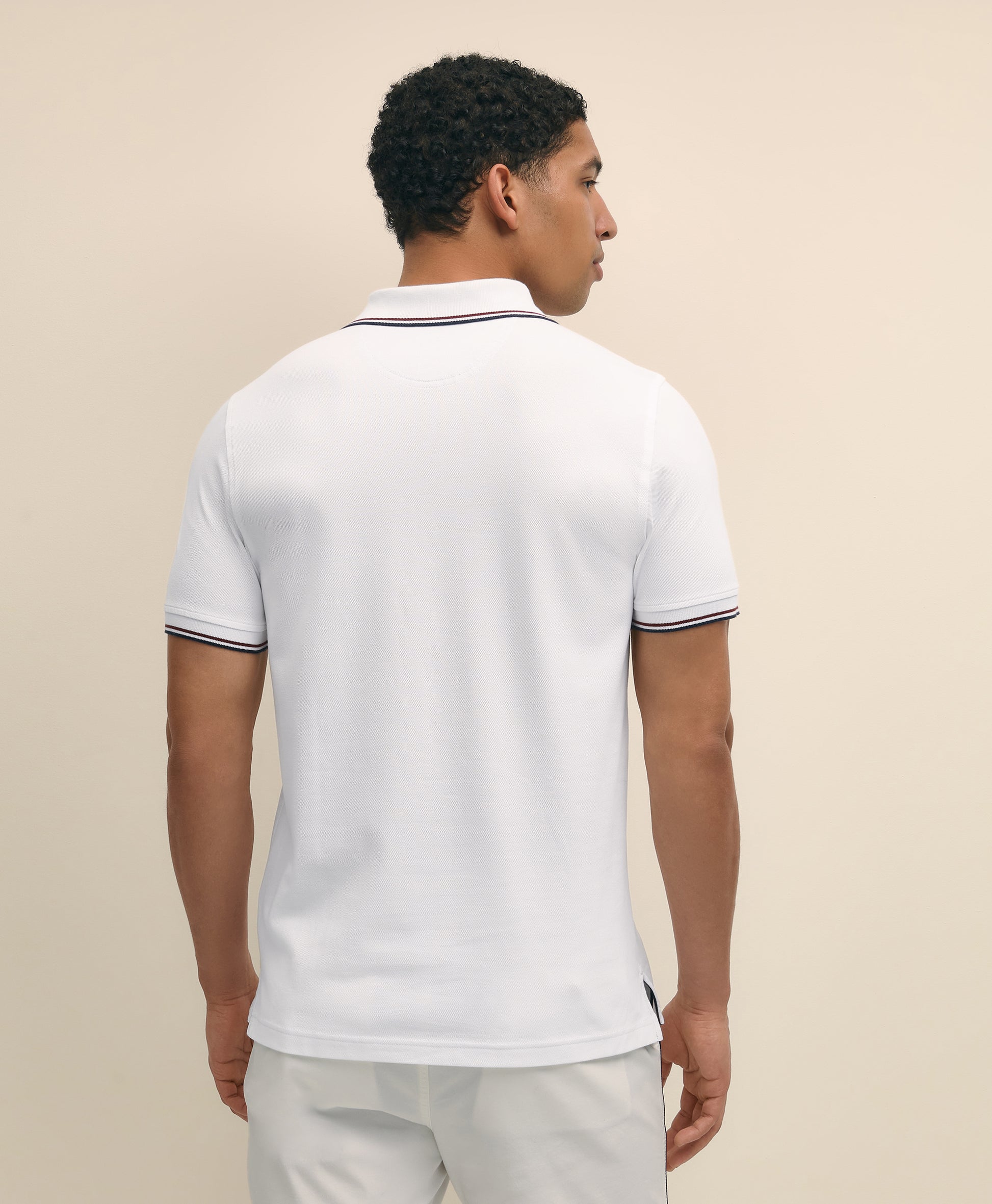 Man wearing a white polo shirt with black trim