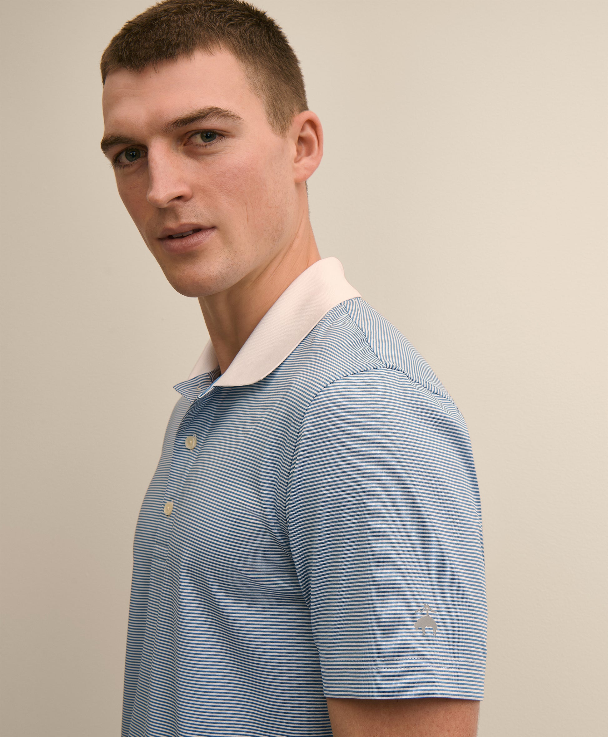 Man wearing a blue striped polo shirt with a beige collar