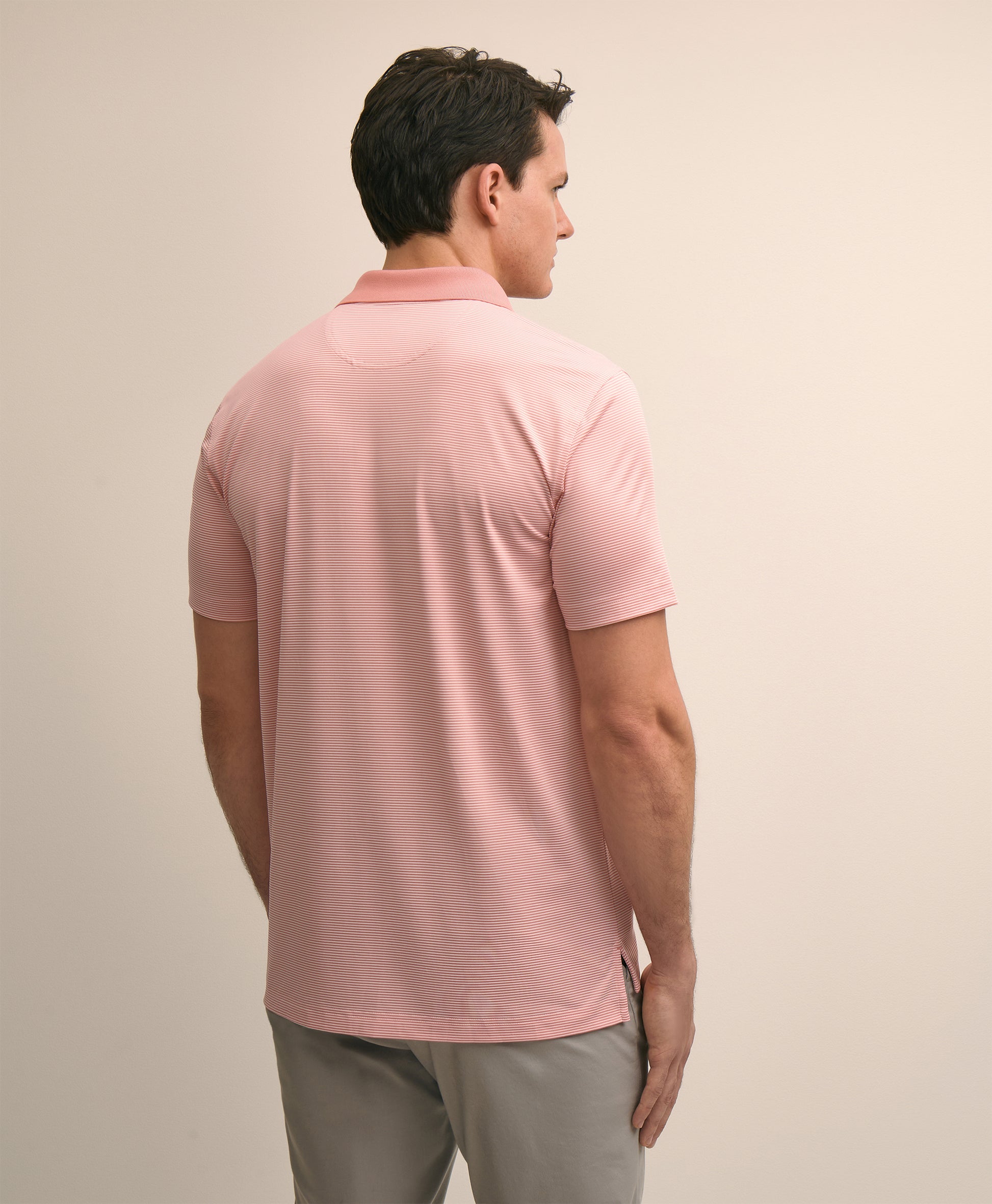 Man wearing a pink polo shirt
