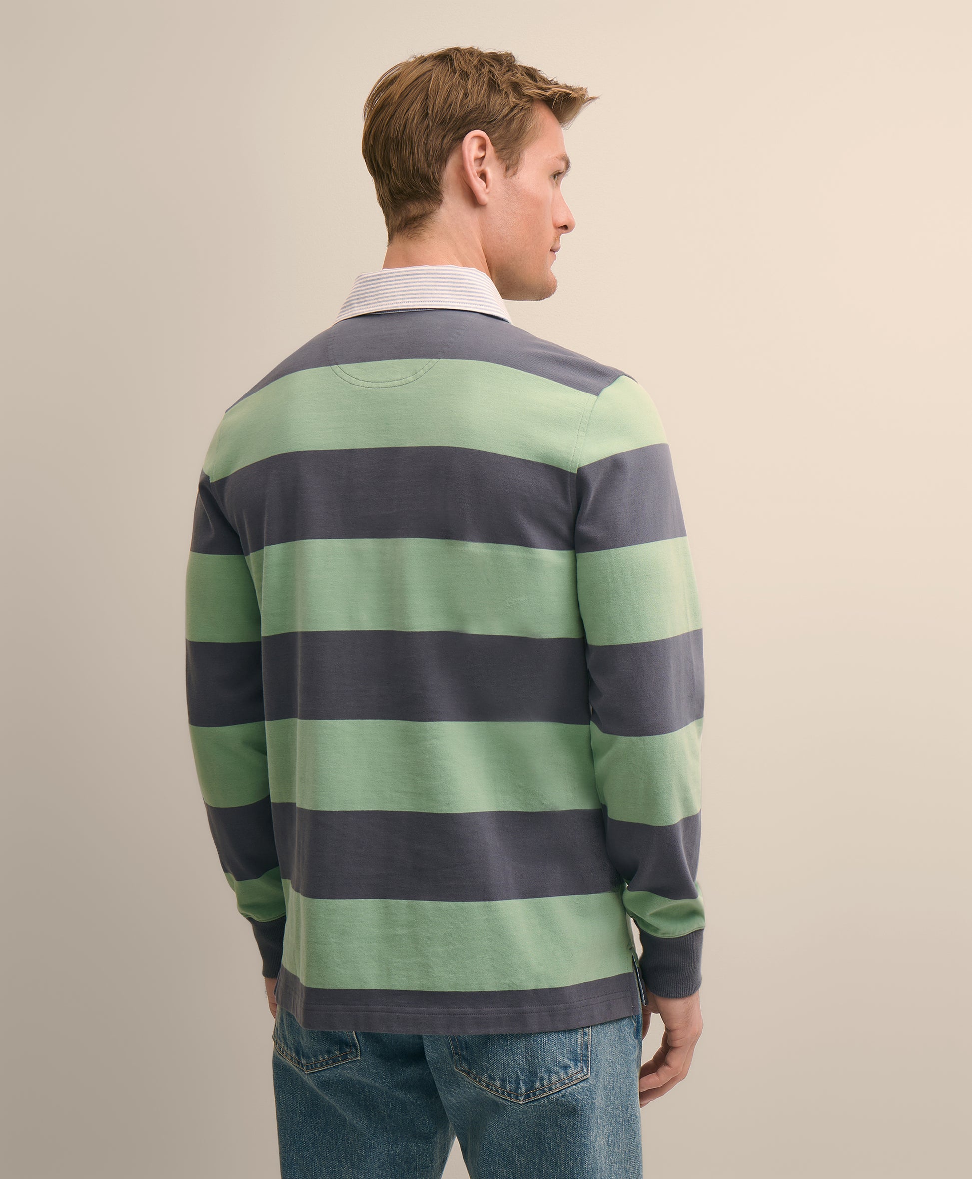 Man wearing a green and navy striped sweater