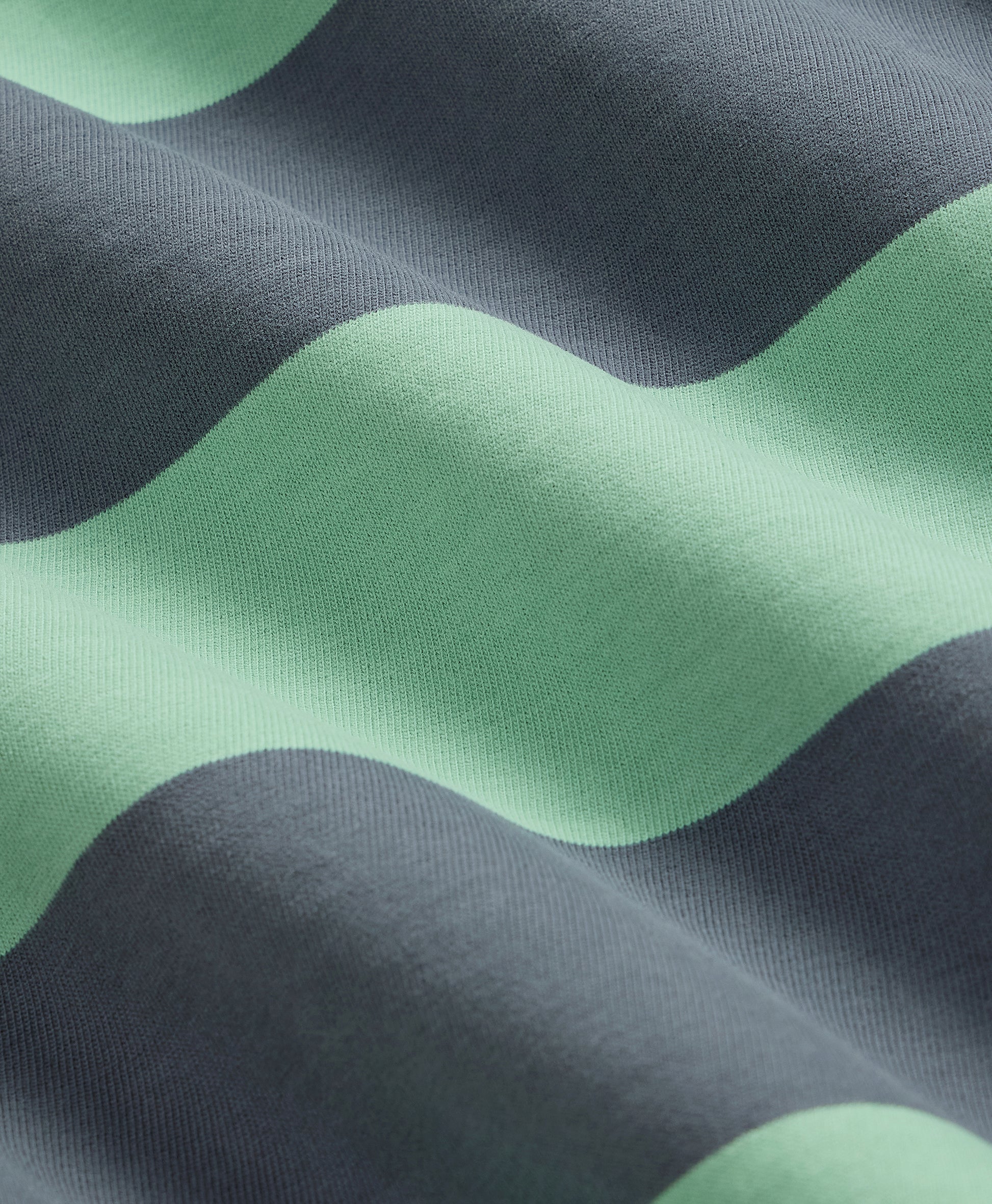 Close-up of fabric with green and gray wavy pattern