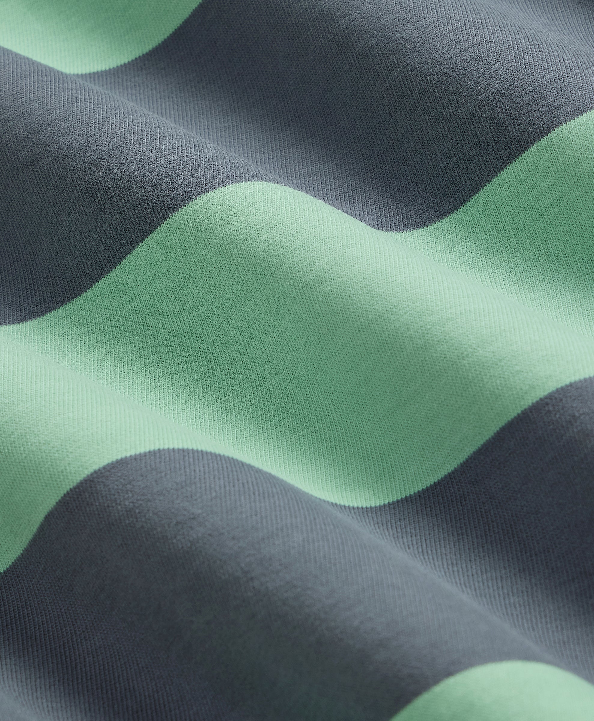 Close-up of fabric with green and gray wavy pattern