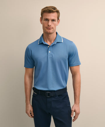 Man wearing a blue polo shirt and dark pants