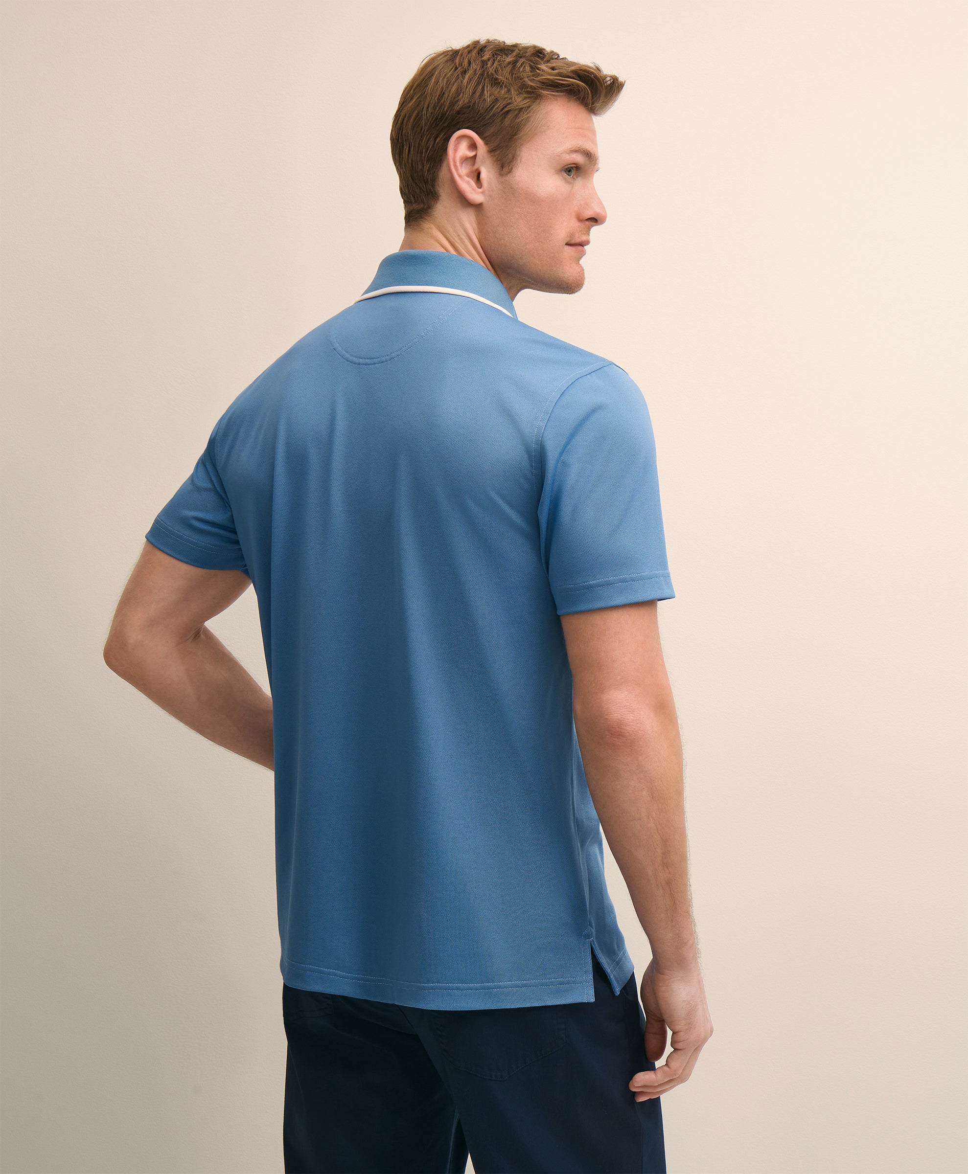 Man wearing a blue polo shirt