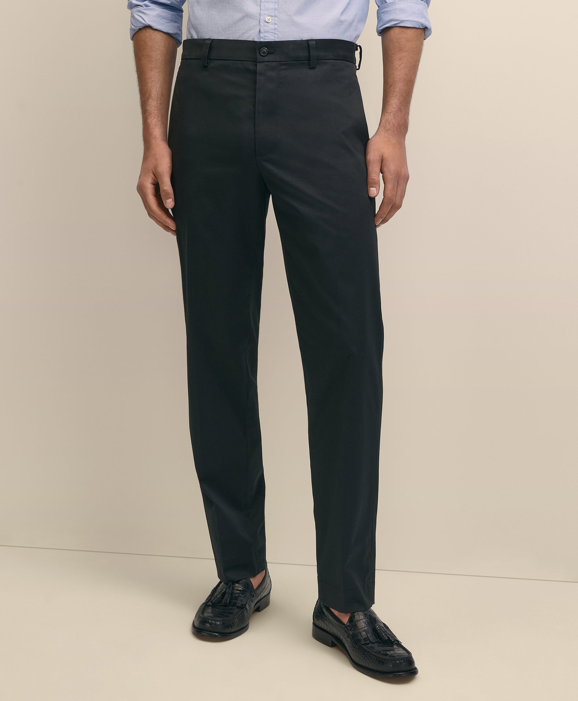 Person wearing black dress pants with a light blue shirt