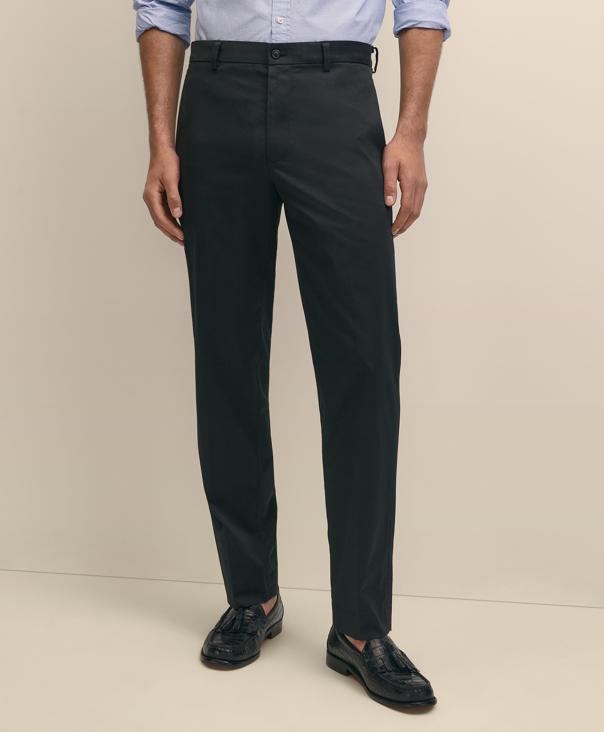 Person wearing black dress pants with a light blue shirt