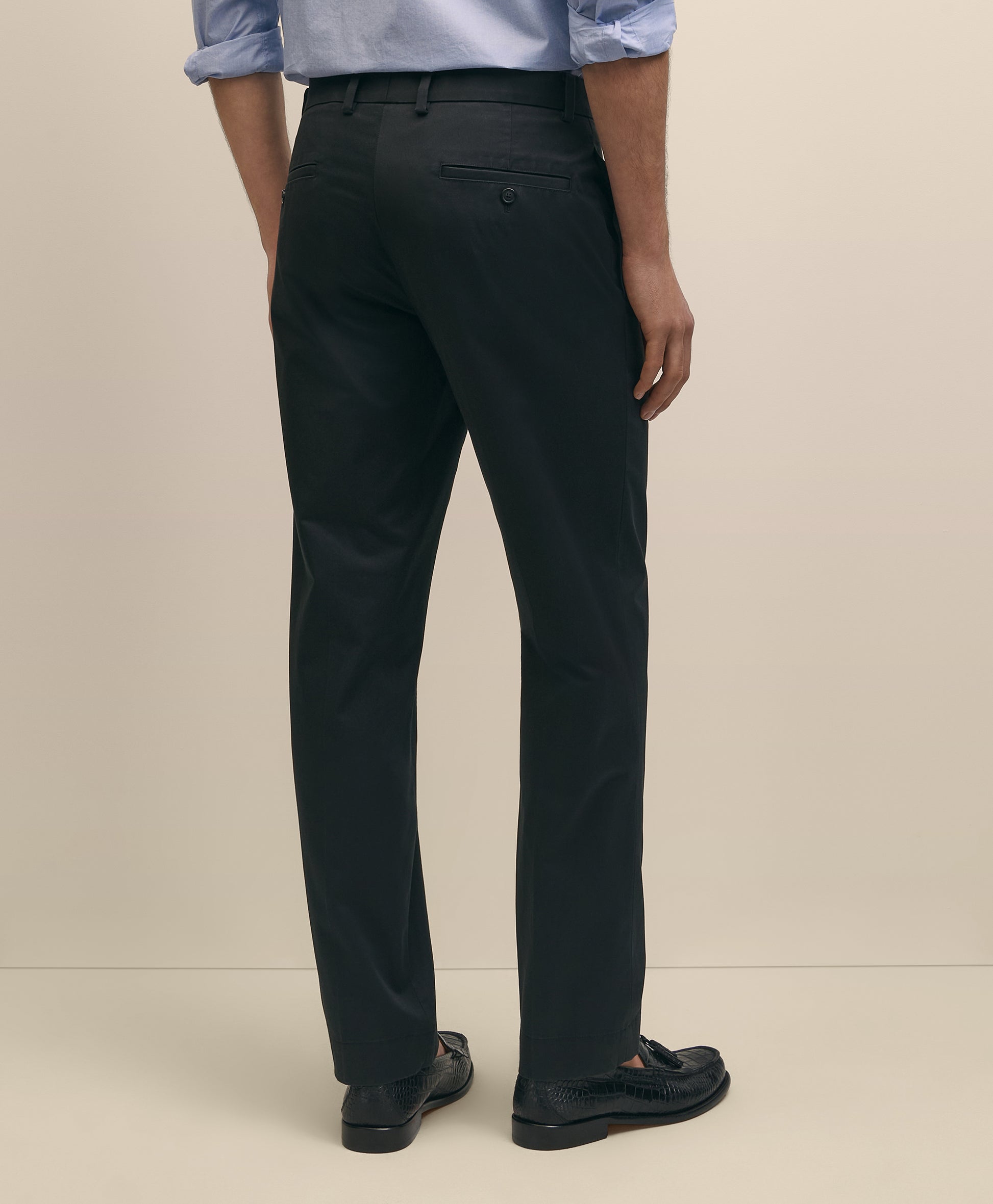 Person wearing black pants and a light blue shirt