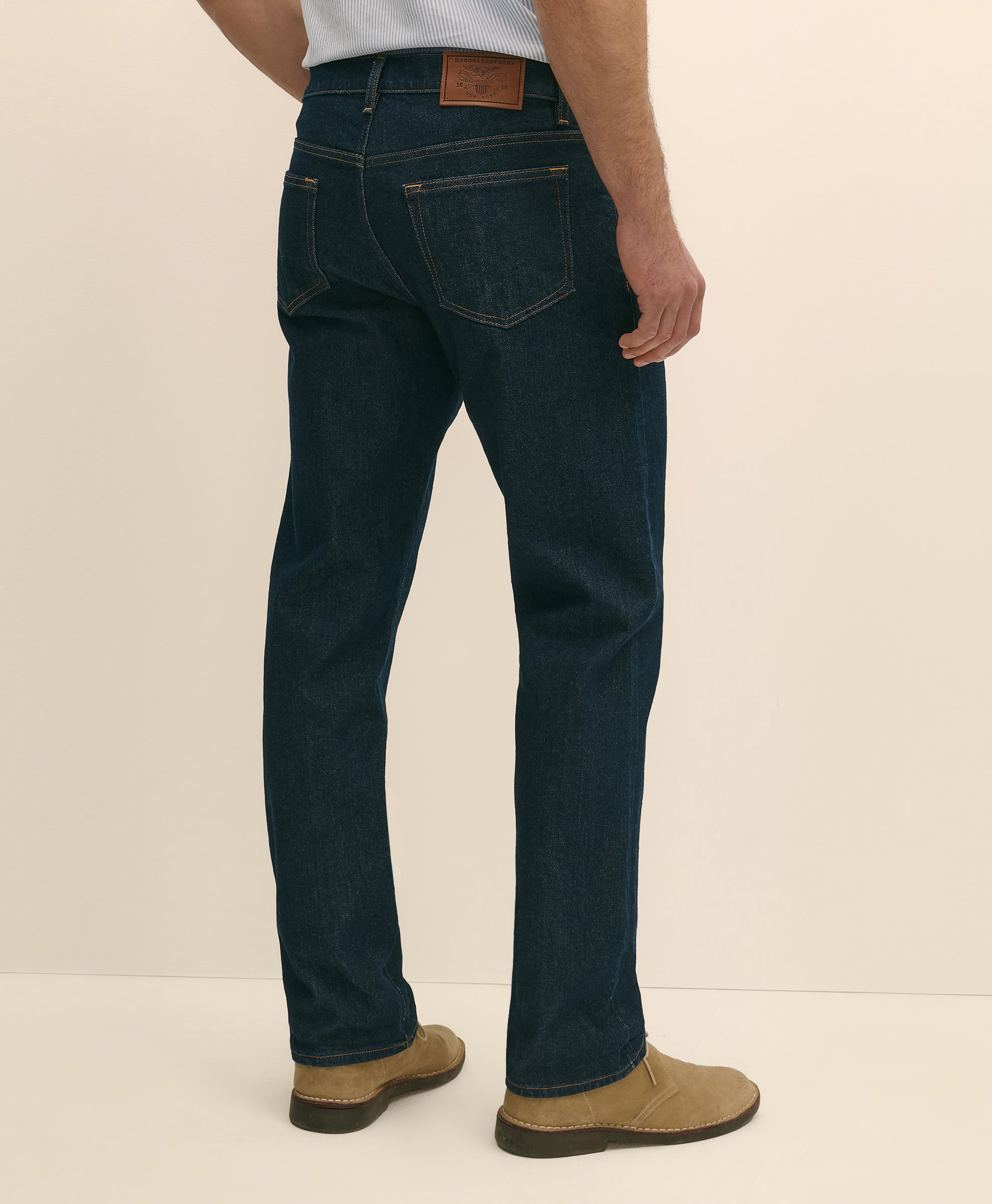Person wearing dark blue jeans