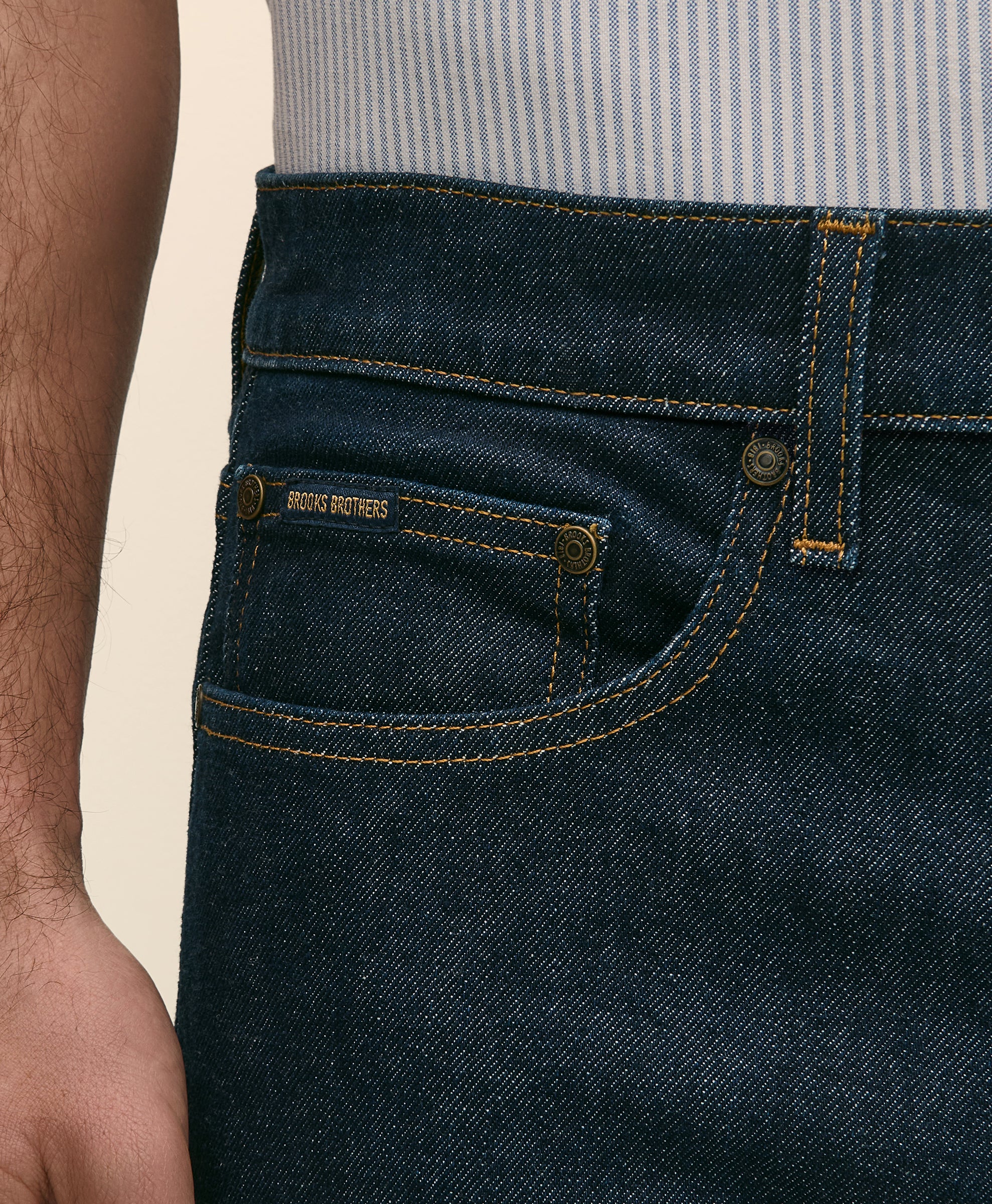 Close-up of dark blue jeans with a brand label