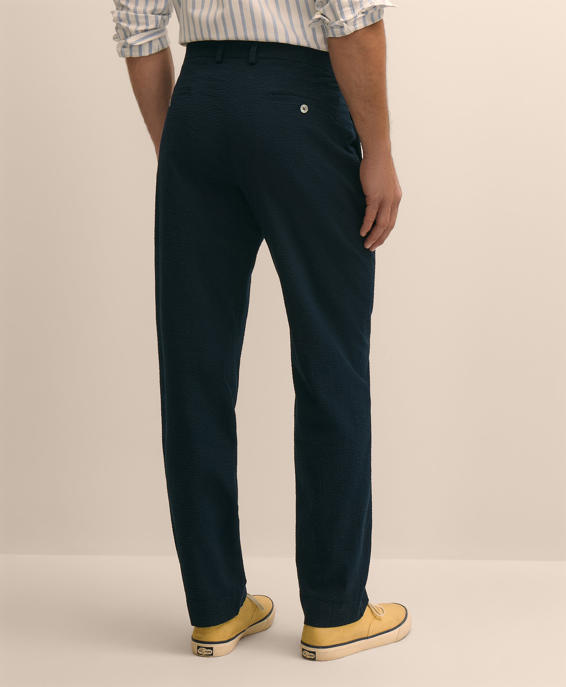 Person wearing navy pants and yellow shoes