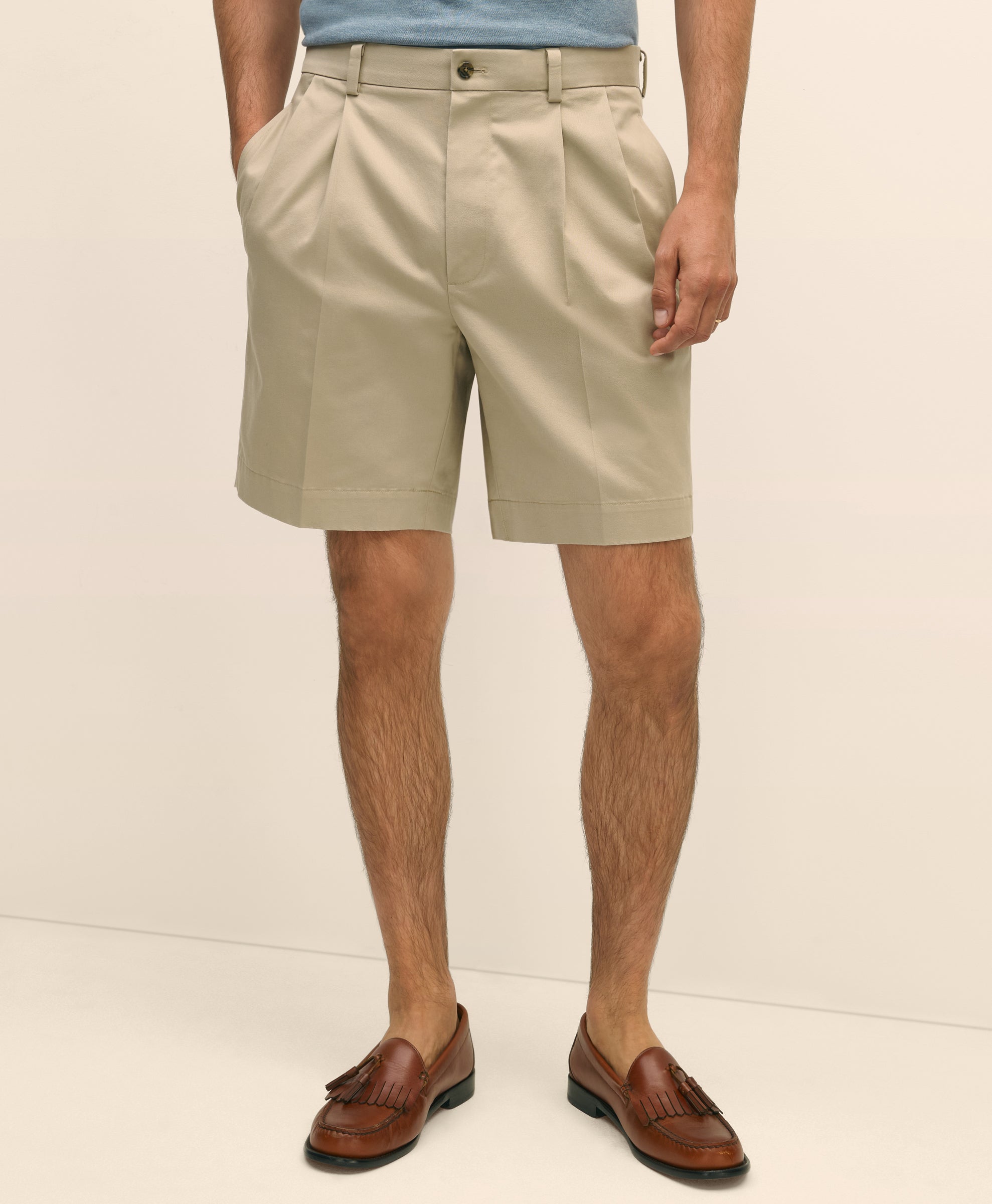 Person wearing beige shorts and brown shoes