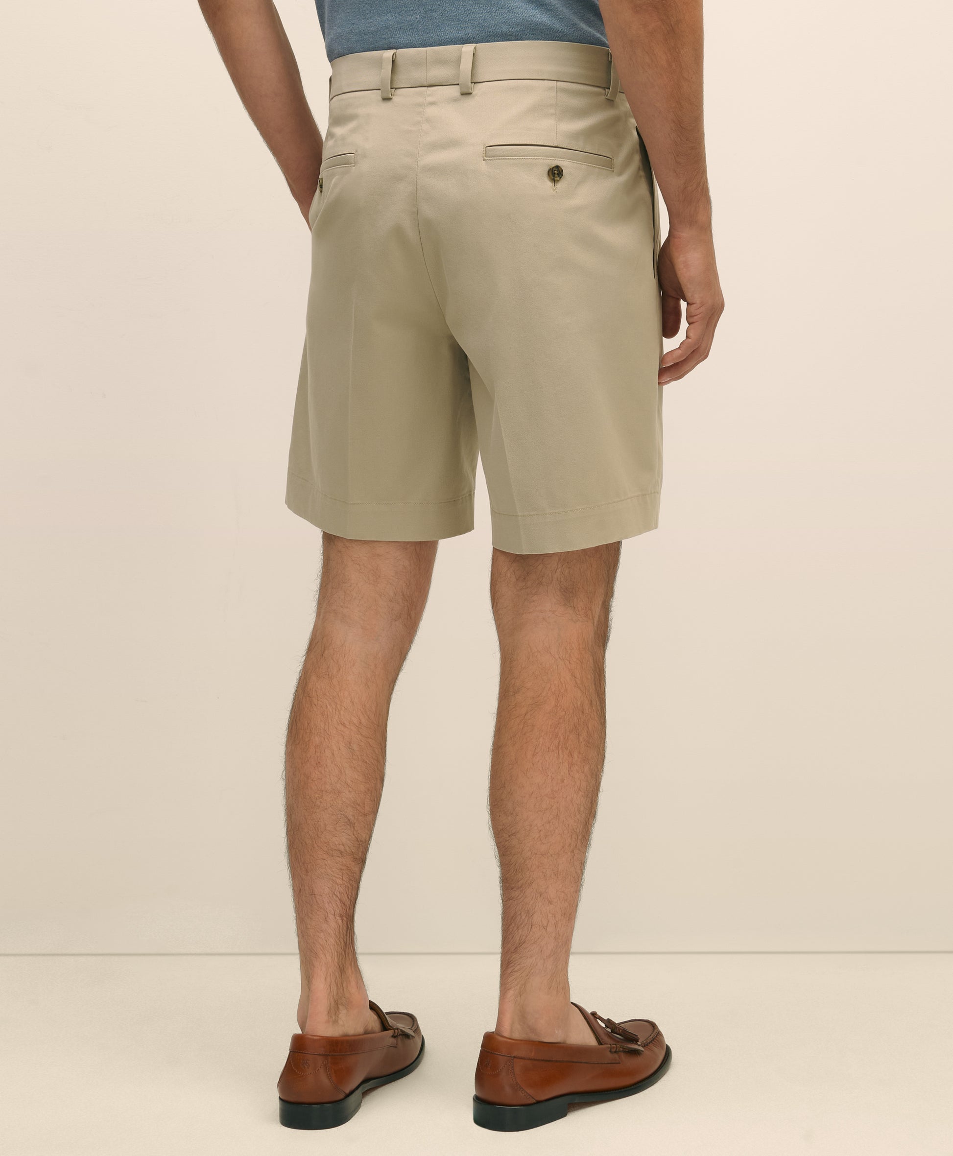 Person wearing beige shorts