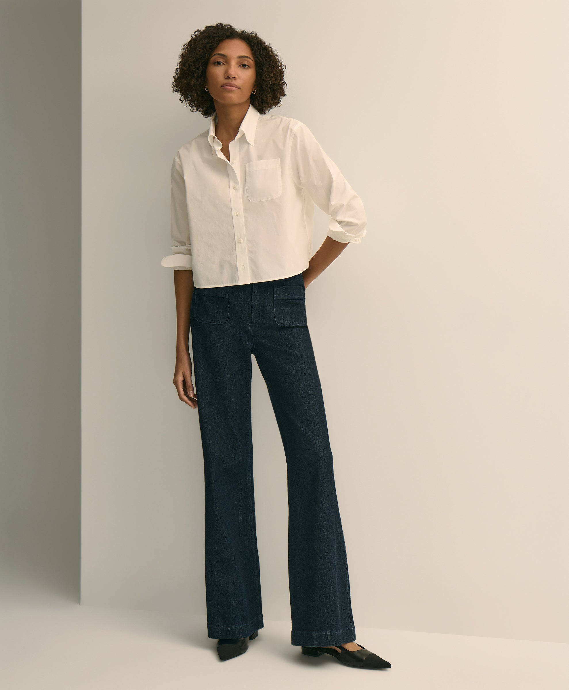 Woman wearing a white shirt and dark blue pants